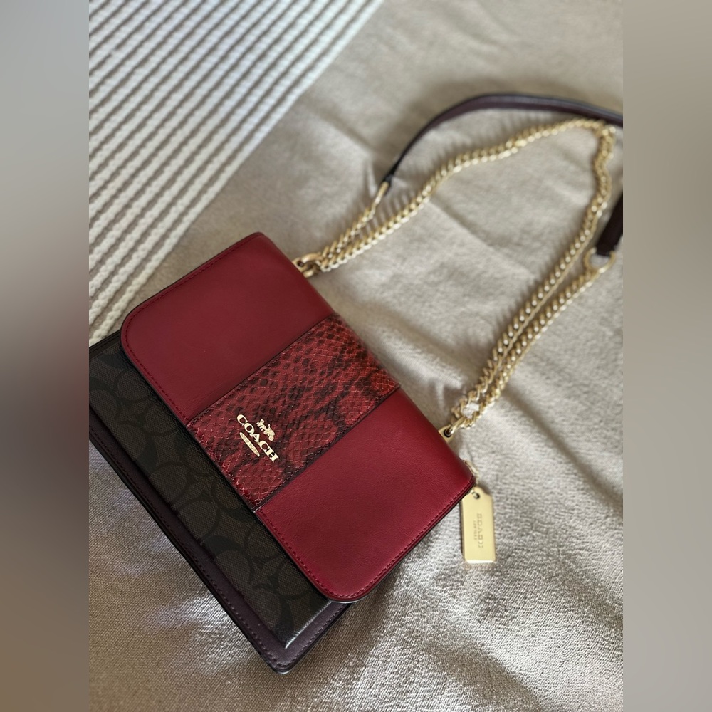 Red and brown coach logo crossbody bag